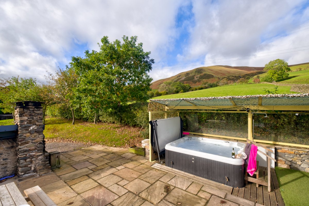 Hot tub under glazed gazebo